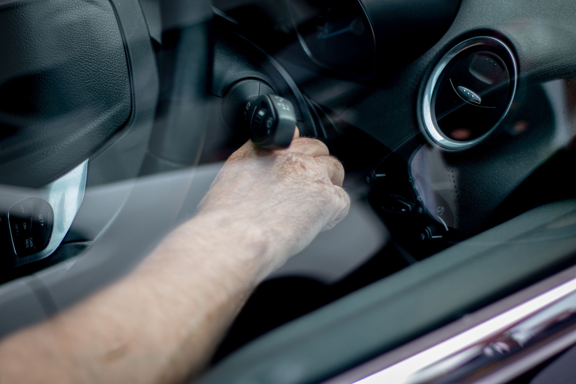 Car key being inserted into vehicle ignition — mobile auto locksmith service